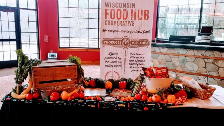 A sign for the Wisconsin Food Hub Cooperative advertises local produce