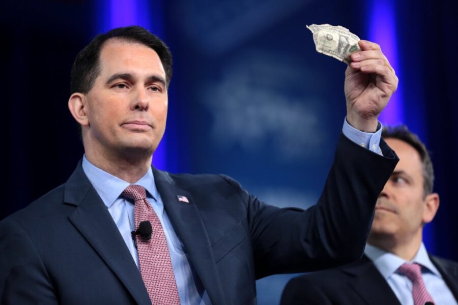 Then-Gov. Scott Walker of Wisconsin holds up a $1 bill at the 2017 Conservative Political Action Conference (CPAC) in National Harbor, Md. (Photo by Gage Skidmore /Creative Commons CC BY-SA 2.0)