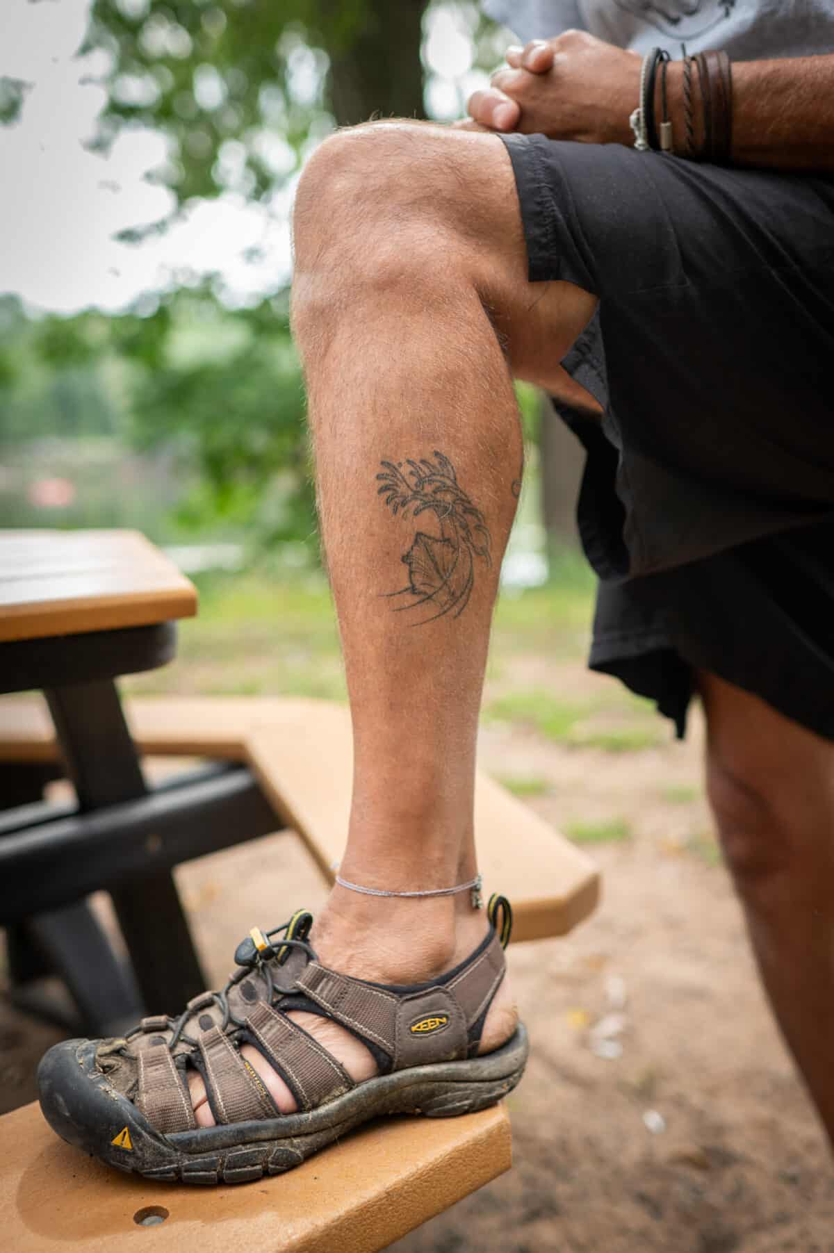 Byron Karns, 63, of Ely, MN, shows off his tattoo of the Threehorn Wartyback mussel, a native species in the St. Croix river on September 11, 2023 in Taylors Falls, MN.