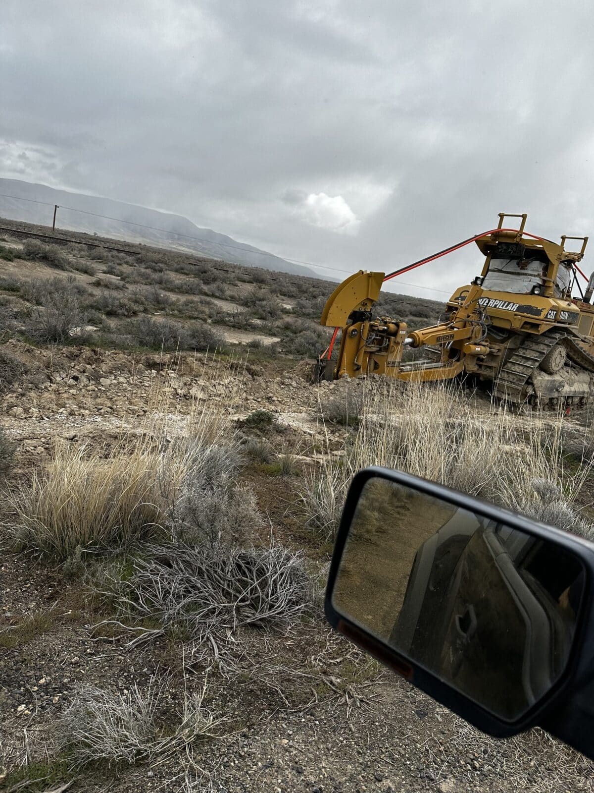 A bulldozer digs into tribal land.